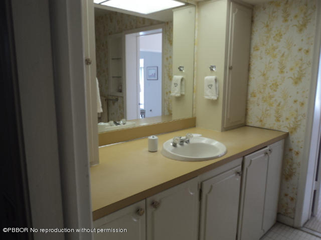 314 Cedar Key Circle Atlantis, FL 33462 - Photo 16 of 23 a bathroom with a sink and a mirror