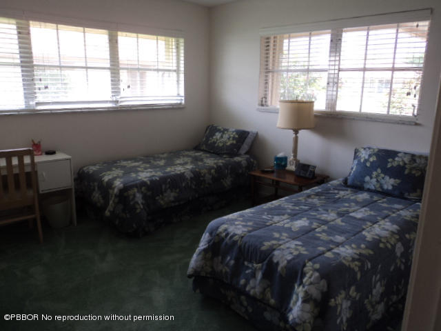 314 Cedar Key Circle Atlantis, FL 33462 - Photo 17 of 23 a bedroom with two beds and a window