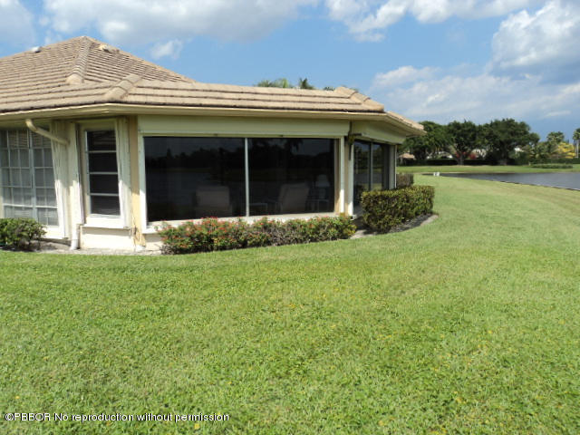 314 Cedar Key Circle Atlantis, FL 33462 - Photo 19 of 23 a view of a house with a garden