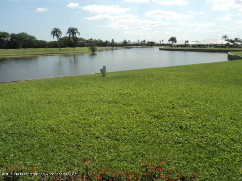 314 Cedar Key Circle Atlantis, FL 33462 - Photo 3 of 23 a view of a lake with houses in the back