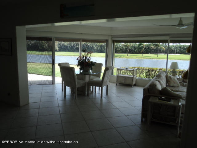 314 Cedar Key Circle Atlantis, FL 33462 - Photo 4 of 23 a dining room with furniture and a floor to ceiling window