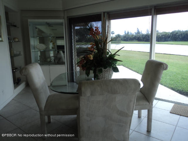 314 Cedar Key Circle Atlantis, FL 33462 - Photo 5 of 23 a view of a porch with chairs and backyard