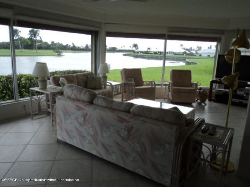 314 Cedar Key Circle Atlantis, FL 33462 - Photo 6 of 23 a living room with patio furniture and a large window