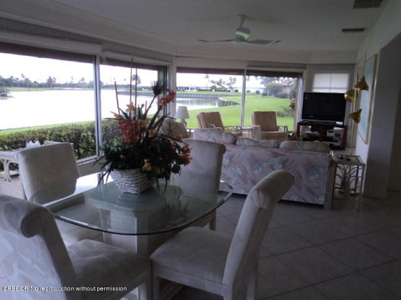 314 Cedar Key Circle Atlantis, FL 33462 - Photo 8 of 23 a living room with patio furniture and a floor to ceiling window