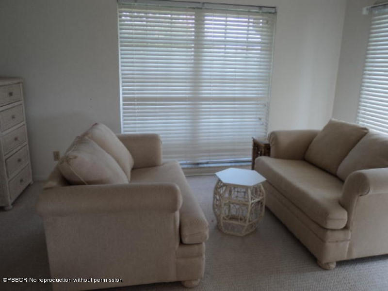 314 Cedar Key Circle Atlantis, FL 33462 - Photo 10 of 23 a living room with furniture and a window