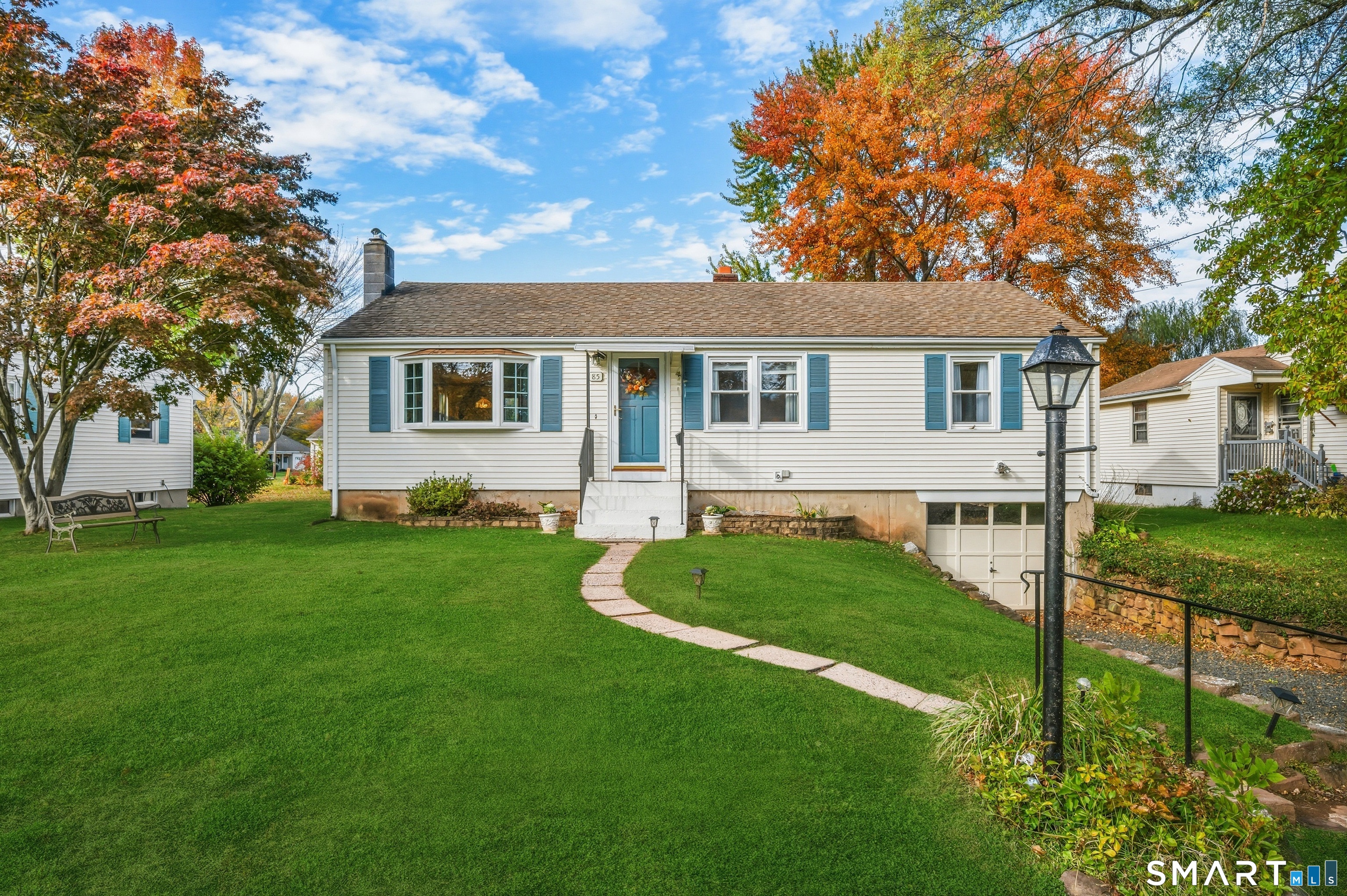 a front view of house with yard and green space