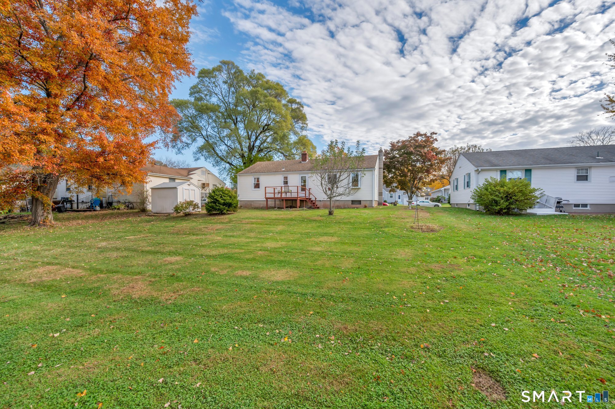85 Florence Street Newington, CT 06111 - Photo 23 of 26 a view of yard with house and trees in the background