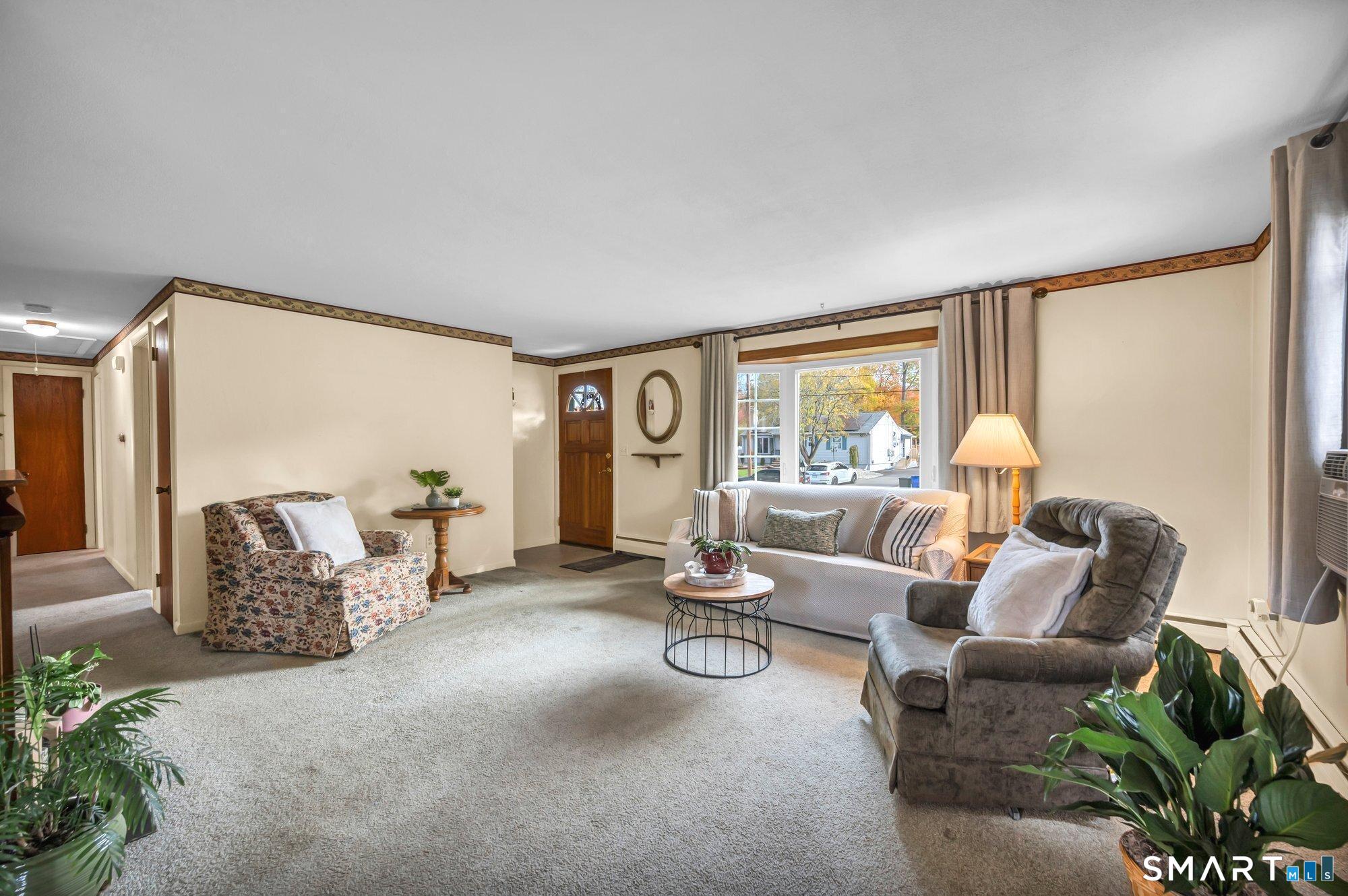 85 Florence Street Newington, CT 06111 - Photo 4 of 26 a living room with furniture and a large window
