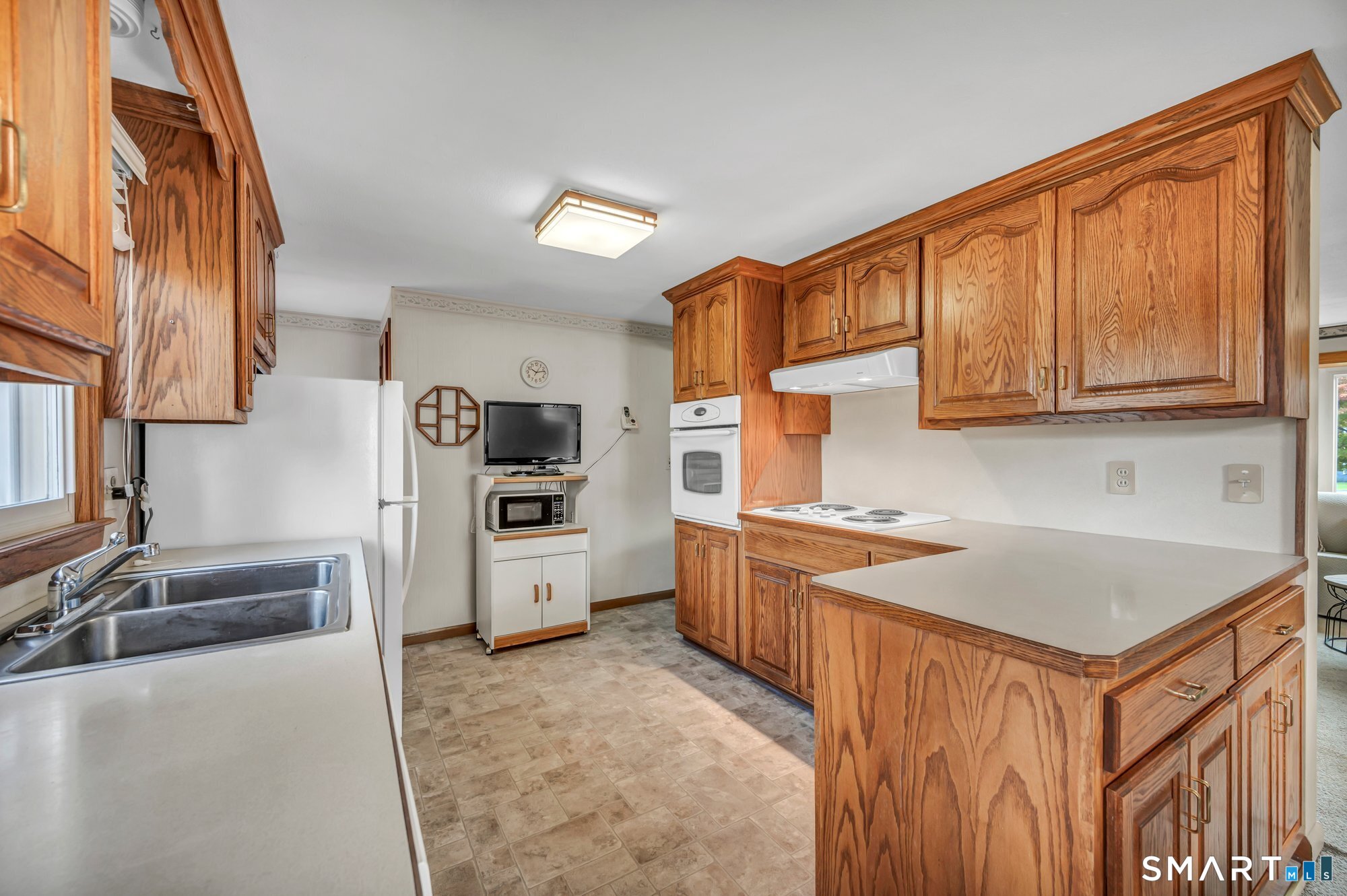 85 Florence Street Newington, CT 06111 - Photo 9 of 26 a kitchen that has a sink and a stove in it