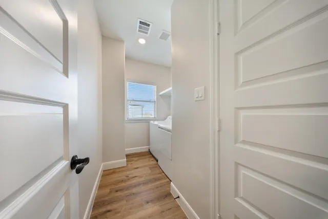 a bathroom with a sink a toilet a vanity and shower