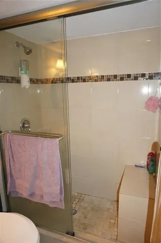 a bathroom with a shower curtain and a toilet