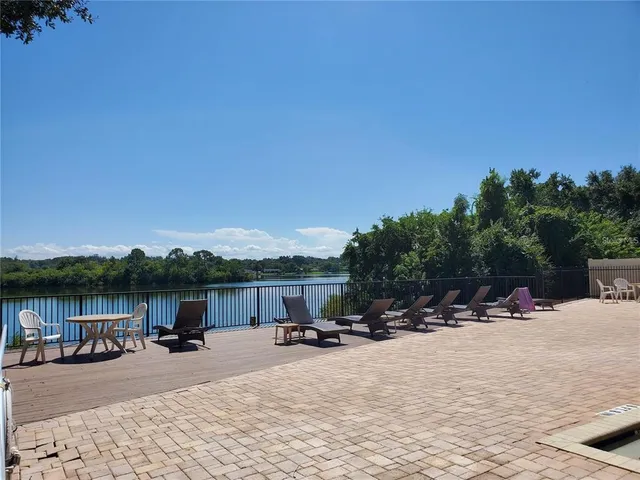 a view of a patio with a table and chairs under an umbrella
