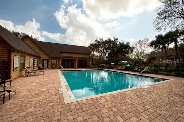 a view of a house with swimming pool in front of it