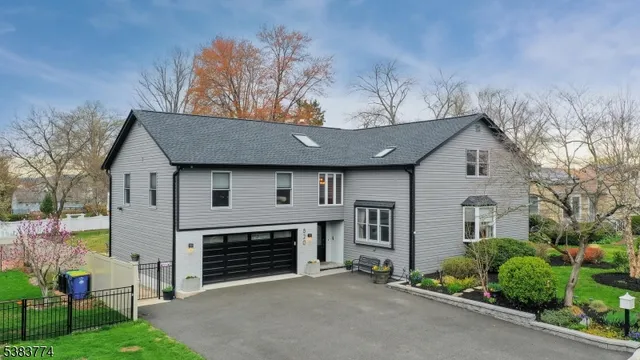 a view of a house with a yard and garage