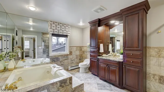 a spacious bathroom with a bathtub sink and mirror