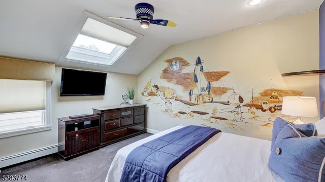 a bedroom with a bed and flat tv screen