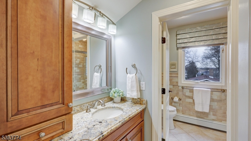 820 Rhine Boulevard Raritan, NJ 08869 - Photo 27 of 47 a bathroom with a granite countertop sink and a mirror