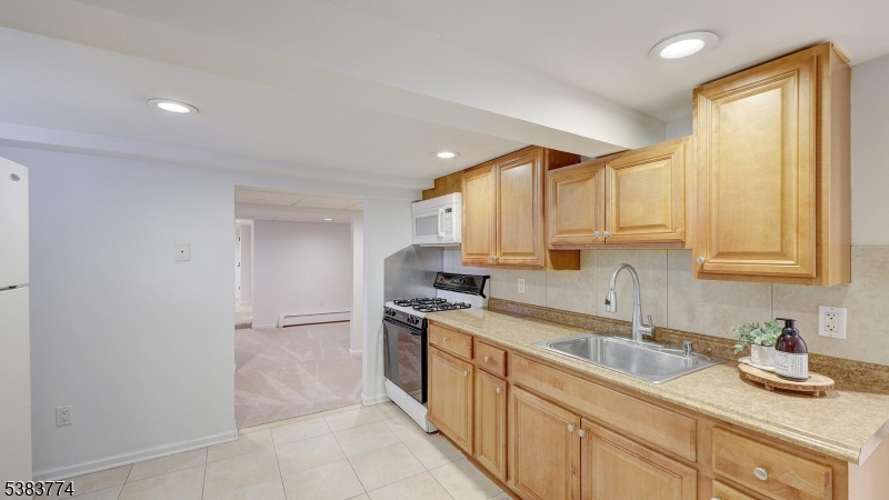 820 Rhine Boulevard Raritan, NJ 08869 - Photo 30 of 47 a kitchen with stainless steel appliances granite countertop a sink stove and cabinets