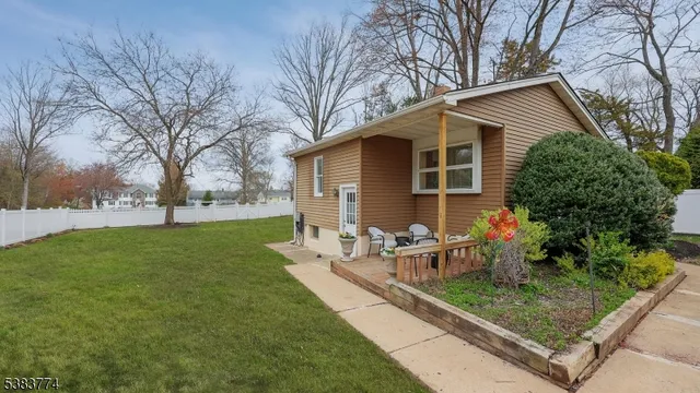 a view of a house with backyard and sitting area