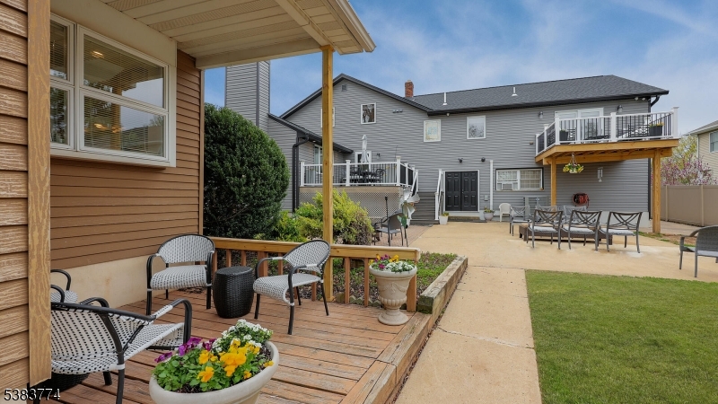 820 Rhine Boulevard Raritan, NJ 08869 - Photo 39 of 47 a view of a patio with table and chairs potted plants and a wooden deck