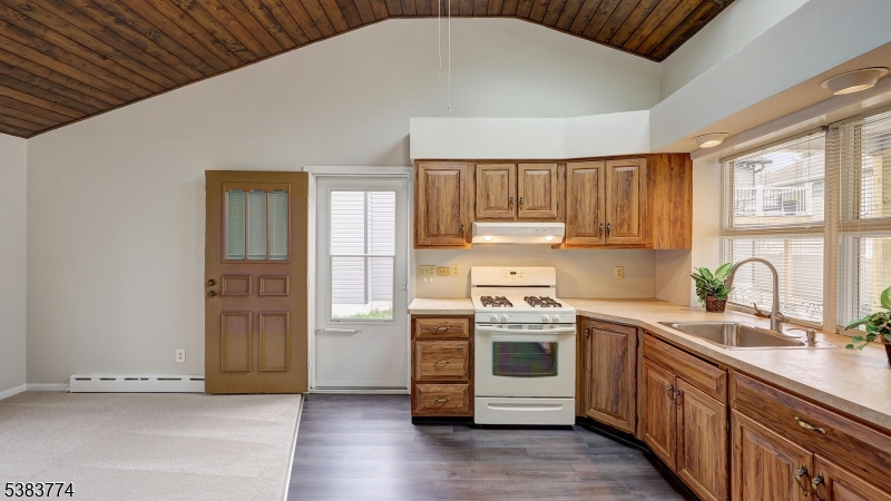 820 Rhine Boulevard Raritan, NJ 08869 - Photo 40 of 47 a kitchen with stainless steel appliances granite countertop a stove a sink and a microwave