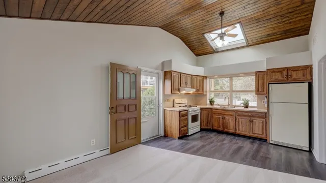 a kitchen with granite countertop stainless steel appliances a stove top oven a sink a counter space and cabinets