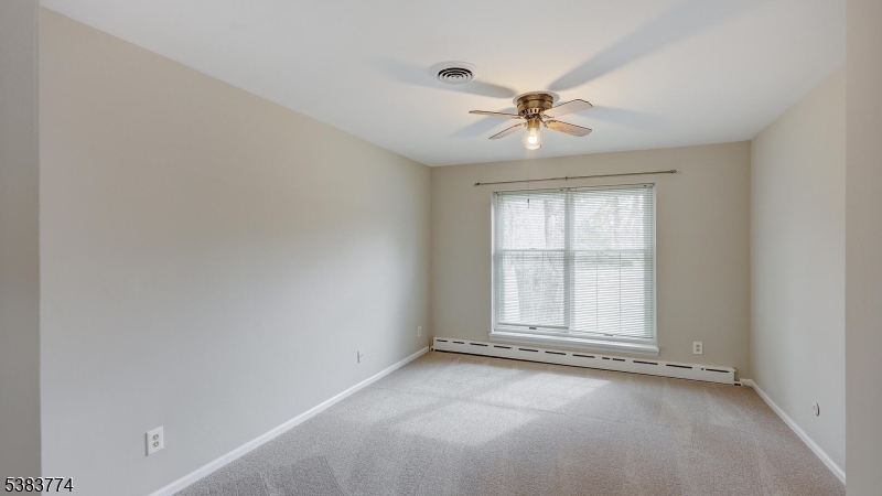 820 Rhine Boulevard Raritan, NJ 08869 - Photo 43 of 47 an empty room with chandelier fan and windows