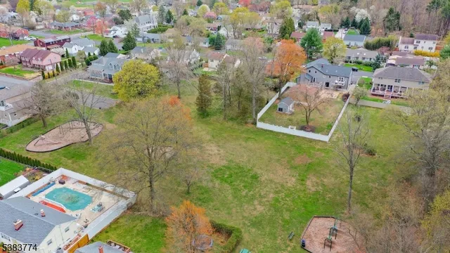 an aerial view of a house with a yard basket ball court
