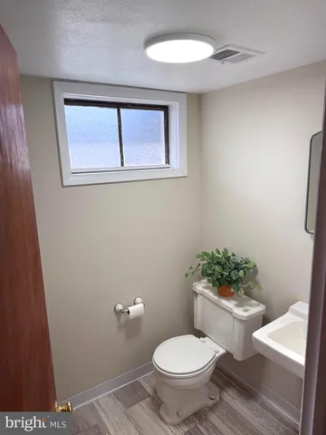 a white toilet sitting next to a bathroom sink