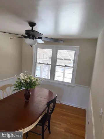 a view of a dining room with furniture and a potted plant
