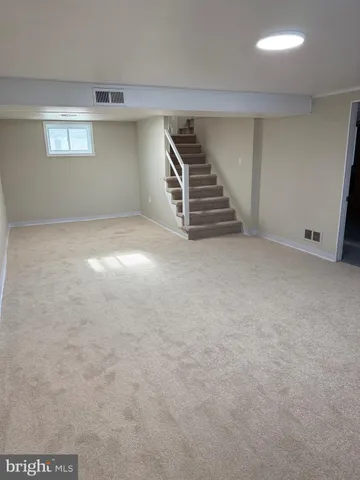 a view of an empty room with stairs