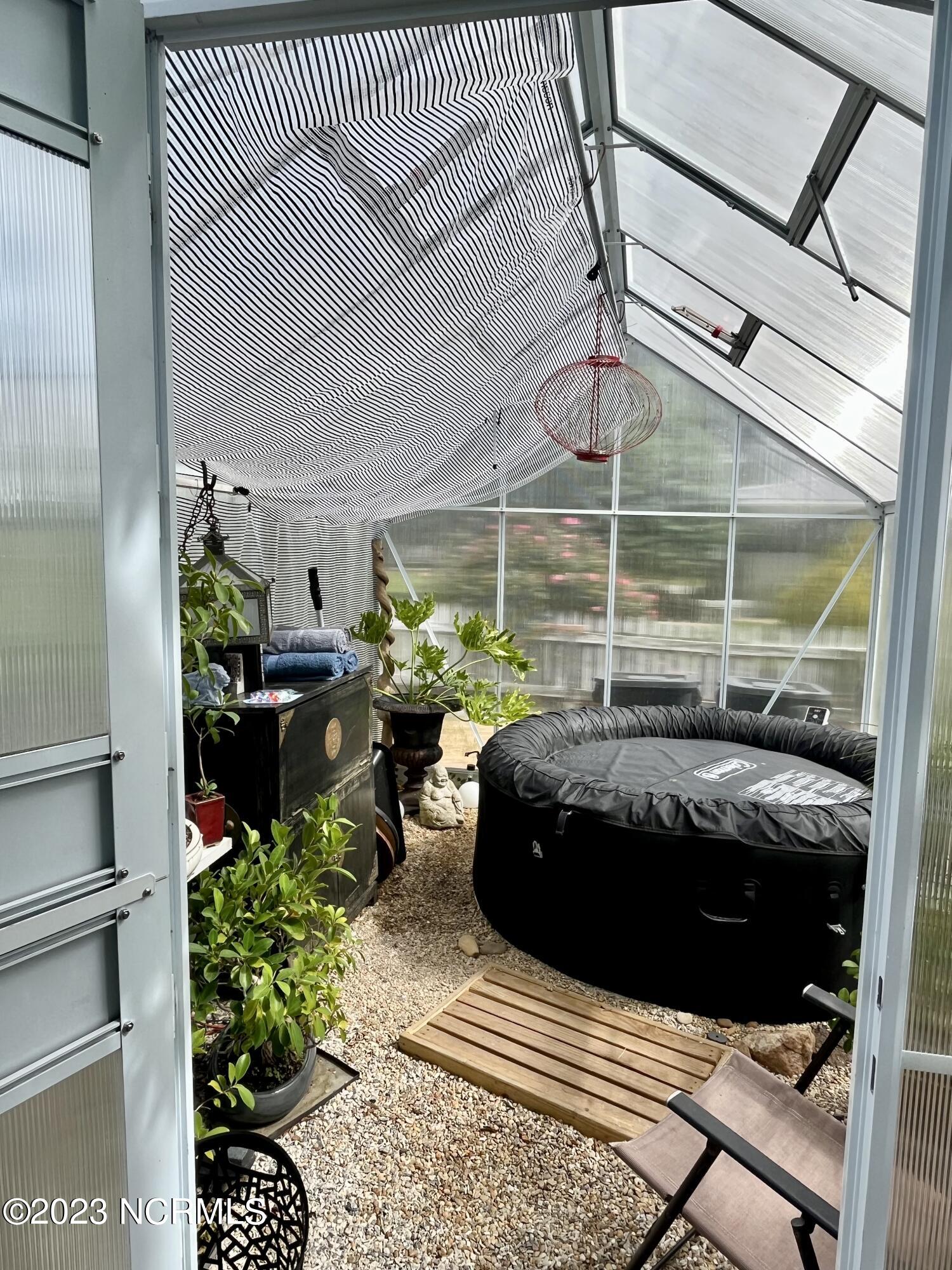 142 Drewery Road Como, NC 27818 - Photo 93 of 113 small greenhouse holds plants and a small hot tub