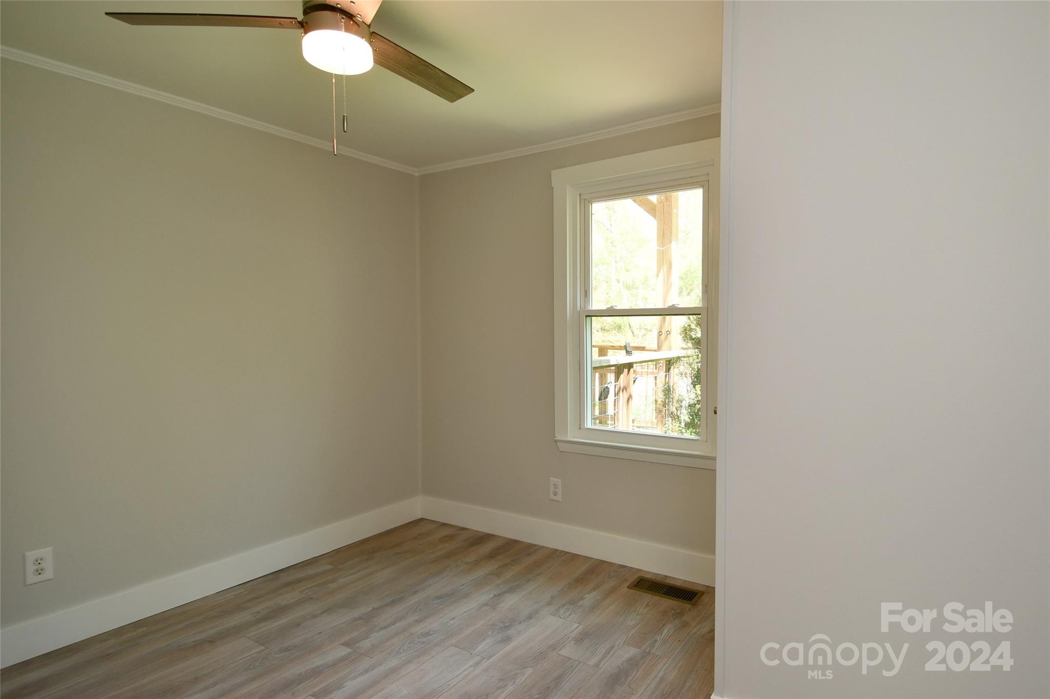 18 Rocky Slope Road Asheville, NC 28804 - Photo 19 of 41 an empty room with wooden floor and windows