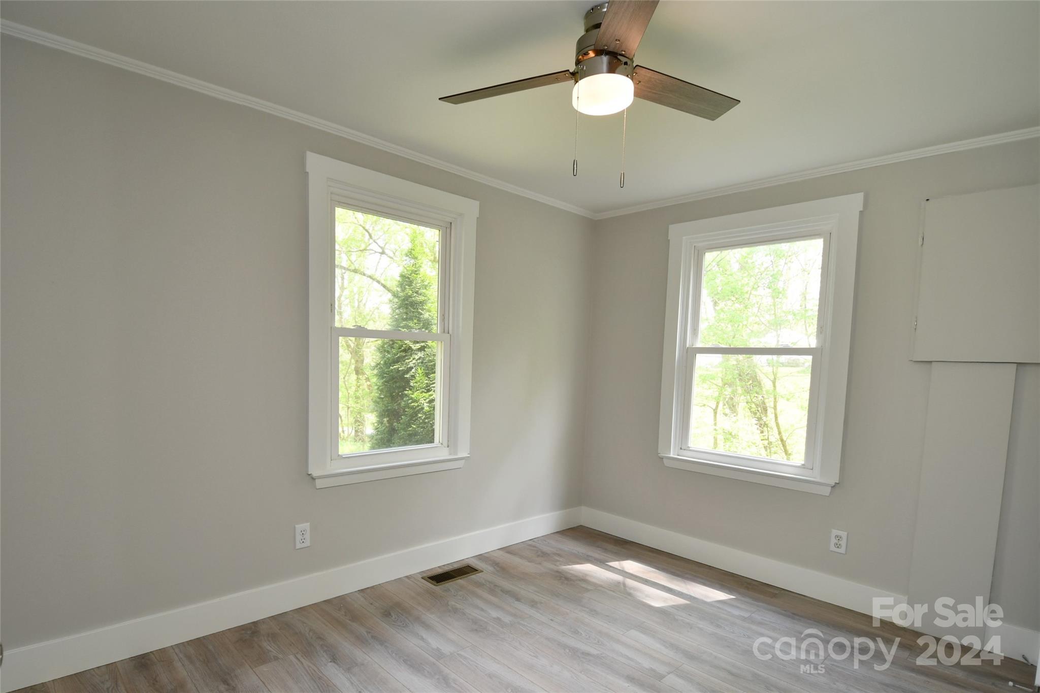 18 Rocky Slope Road Asheville, NC 28804 - Photo 20 of 41 a view of an empty room with a window and wooden floor