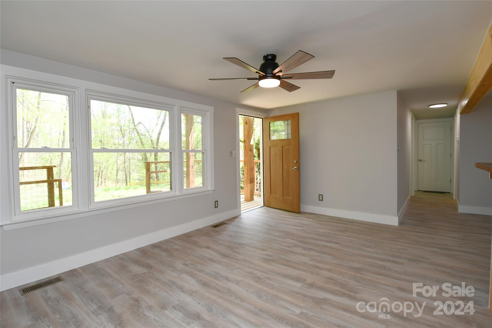 18 Rocky Slope Road Asheville, NC 28804 - Photo 2 of 41 a view of empty room with wooden floor and fan