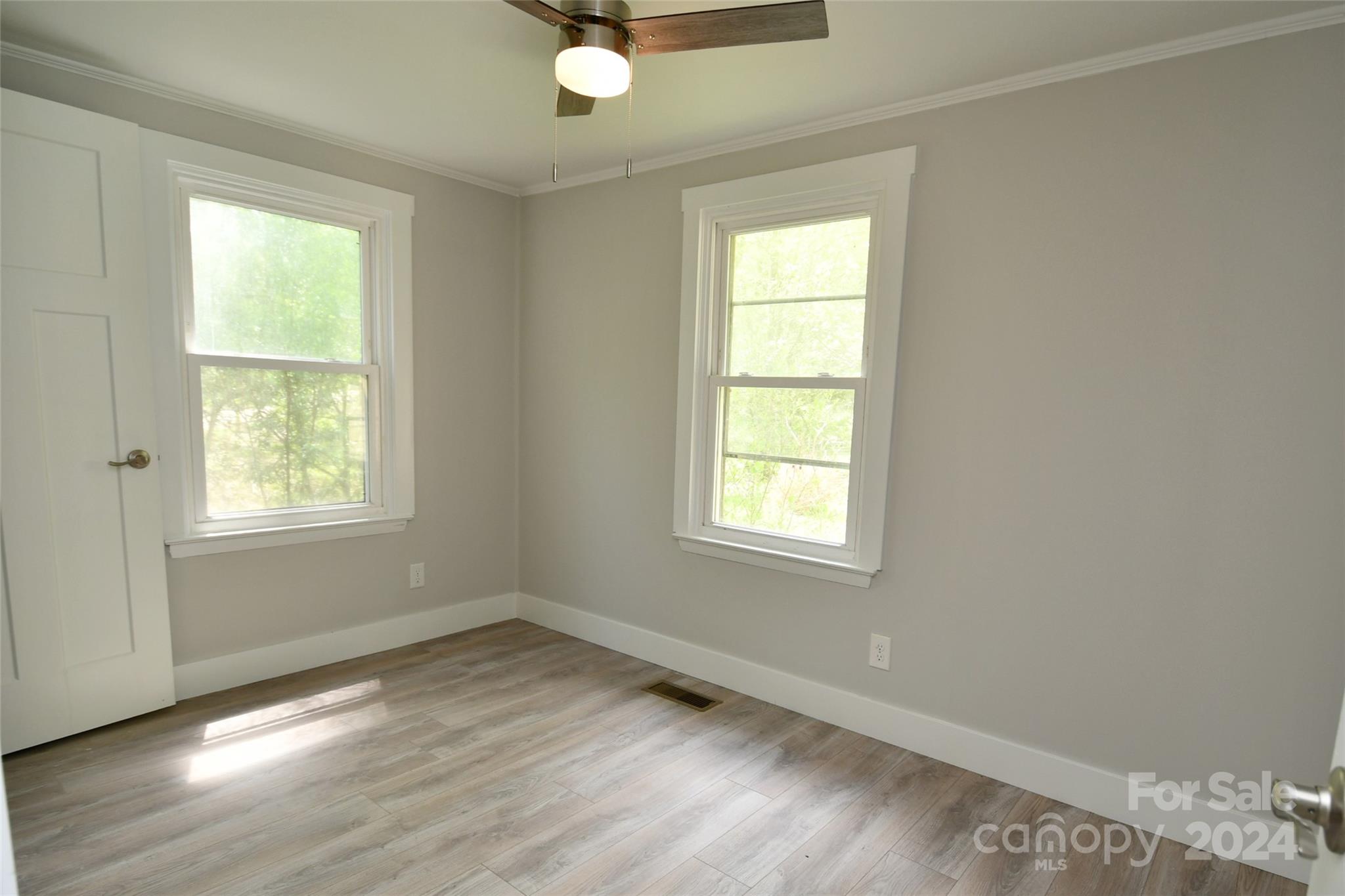18 Rocky Slope Road Asheville, NC 28804 - Photo 21 of 41 an empty room with wooden floor and windows