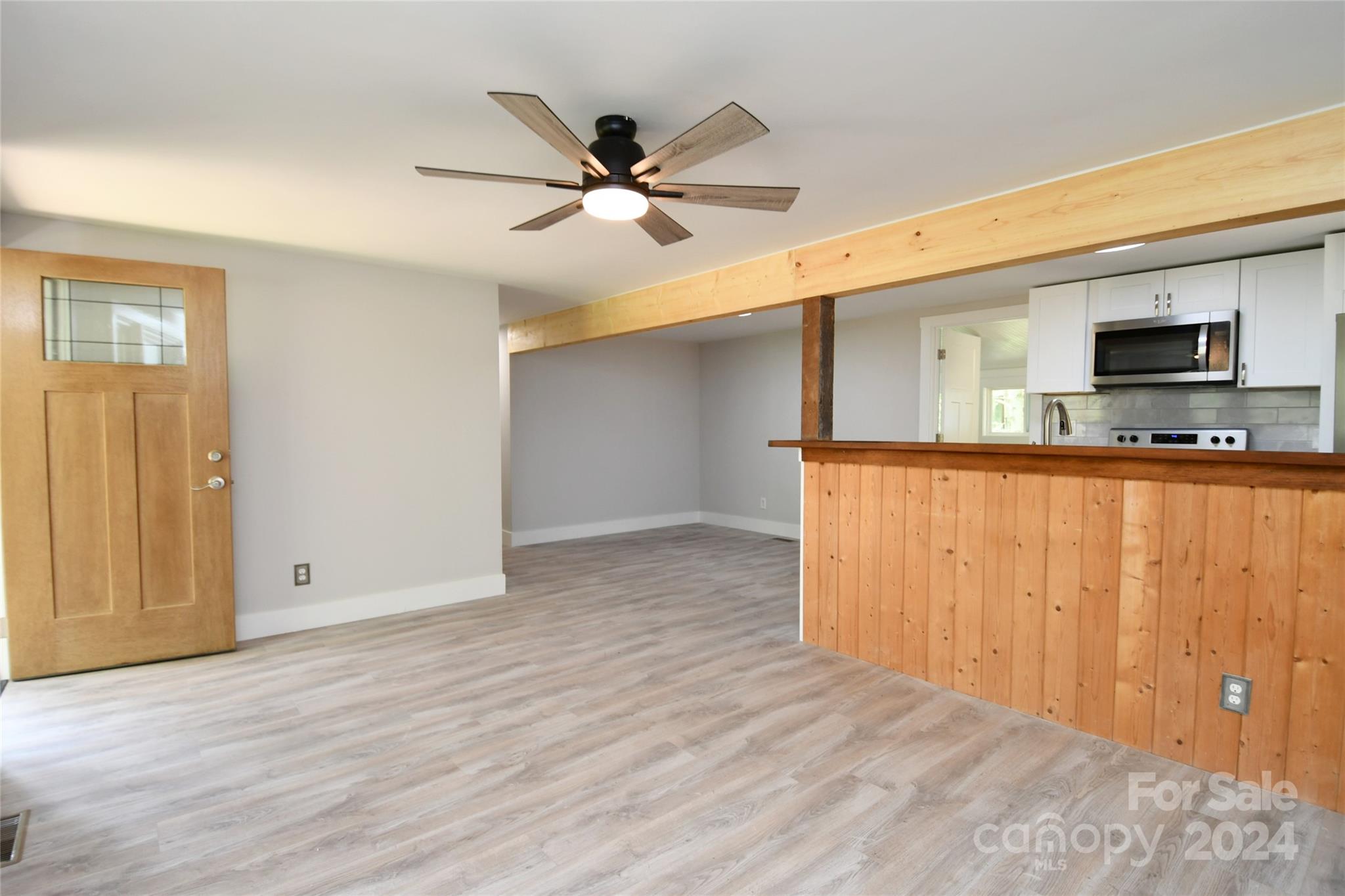 18 Rocky Slope Road Asheville, NC 28804 - Photo 3 of 41 a view of a livingroom with wooden floor and a ceiling fan