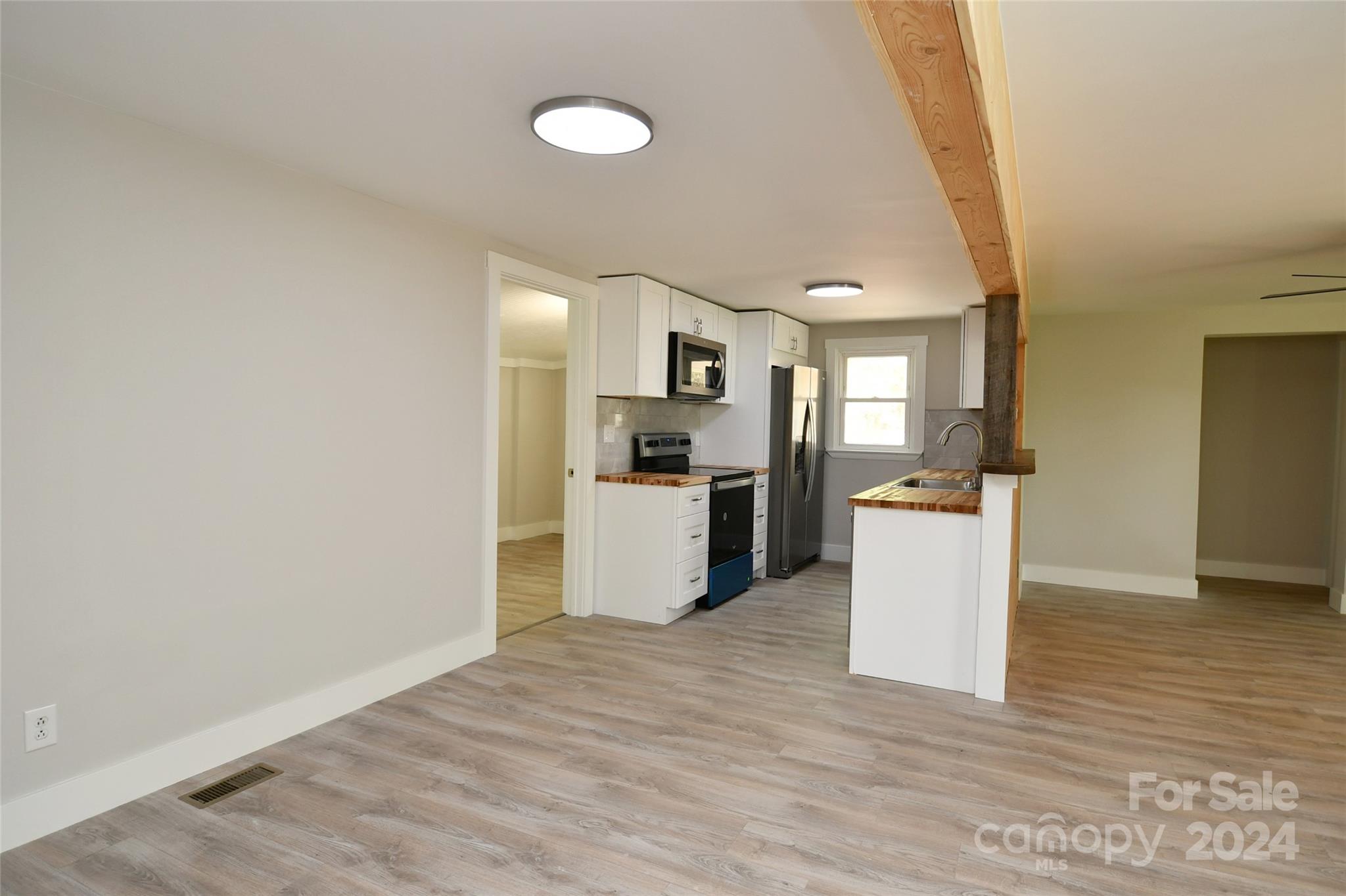 18 Rocky Slope Road Asheville, NC 28804 - Photo 5 of 41 a view of kitchen with refrigerator microwave and wooden floor
