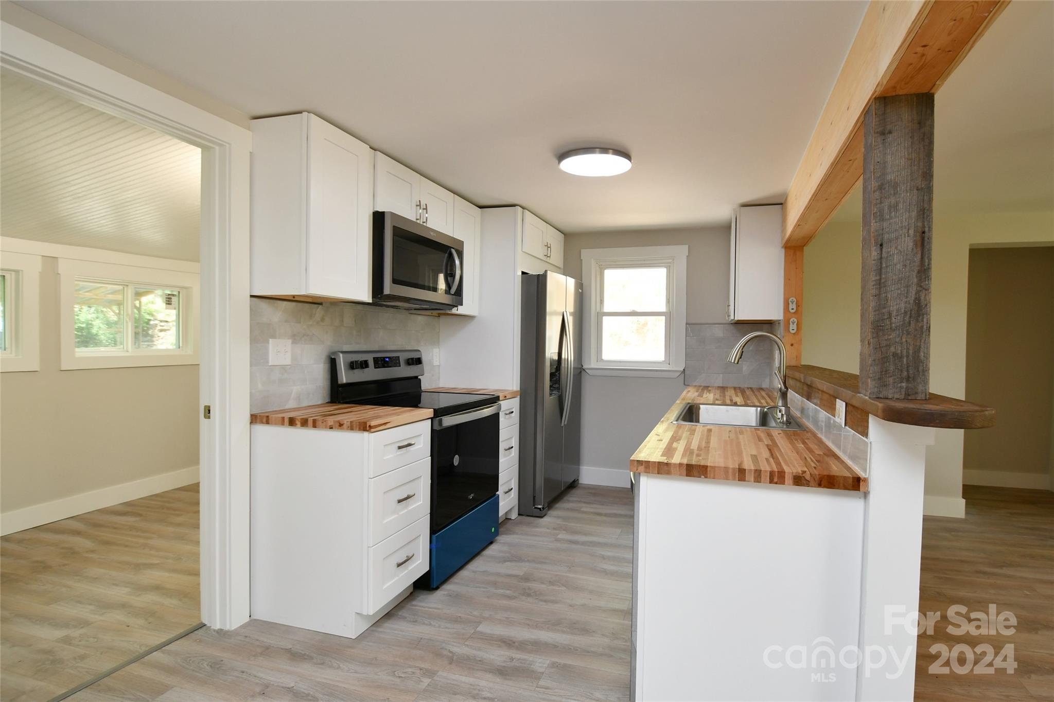 18 Rocky Slope Road Asheville, NC 28804 - Photo 7 of 41 a kitchen with granite countertop a sink stove and refrigerator