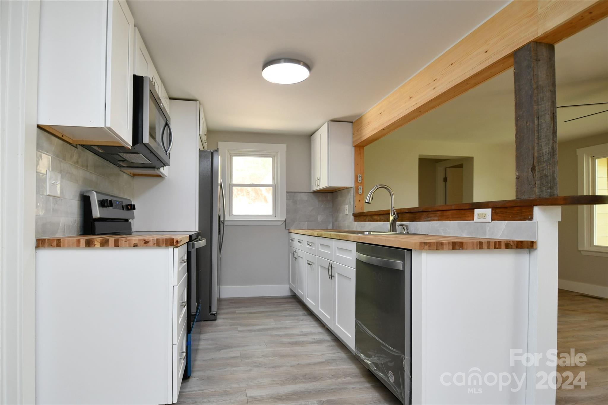 18 Rocky Slope Road Asheville, NC 28804 - Photo 8 of 41 a kitchen with a sink stove and refrigerator
