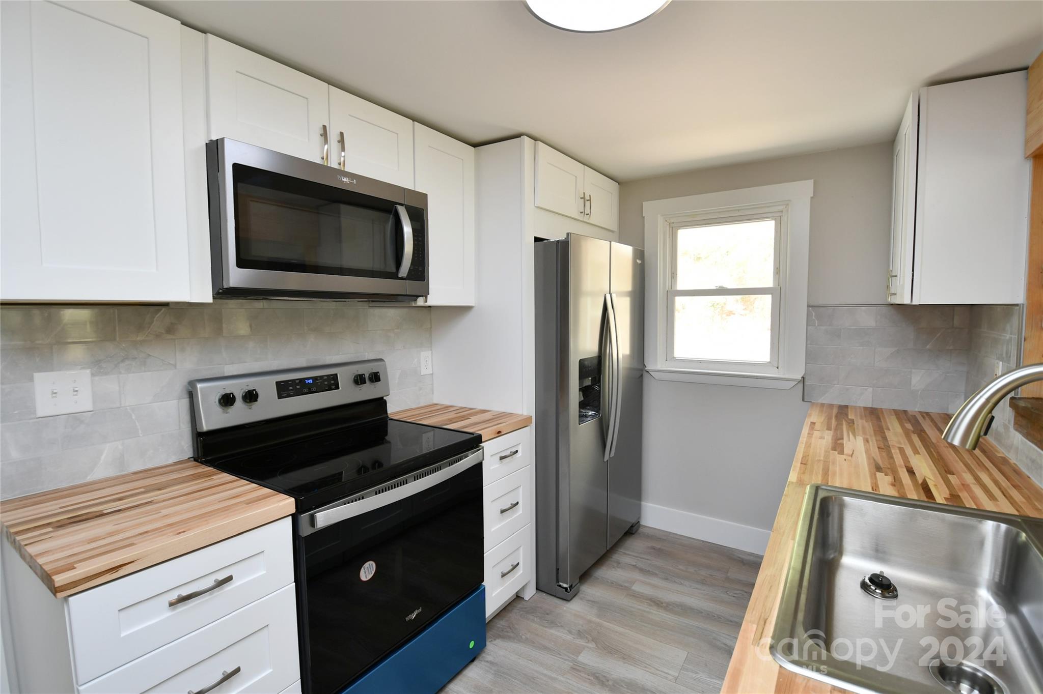 18 Rocky Slope Road Asheville, NC 28804 - Photo 9 of 41 a kitchen with a stove and a microwave