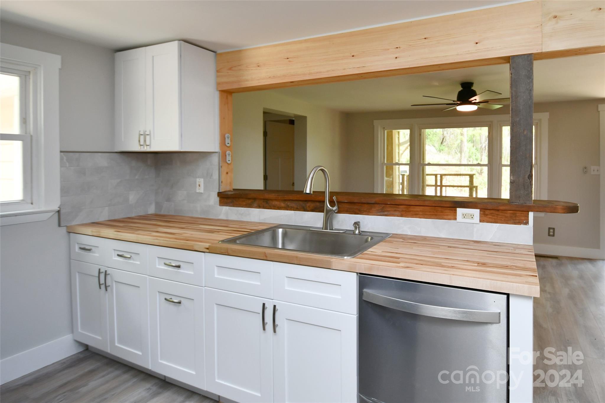 18 Rocky Slope Road Asheville, NC 28804 - Photo 10 of 41 a kitchen with a sink dishwasher and cabinets with wooden floor