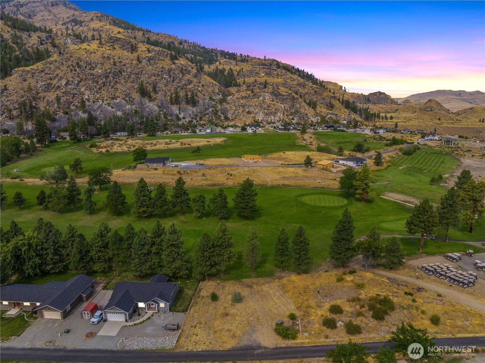 103 Golf Course Drive Pateros, WA 98846 - Photo 1 of 24 a view of a lake with a mountain in the background