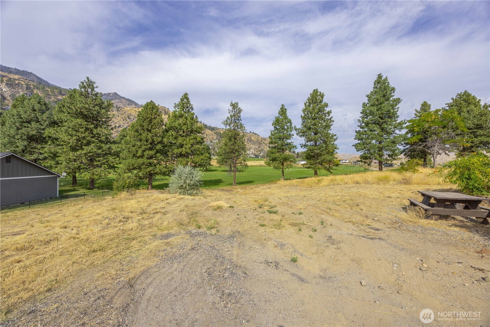 103 Golf Course Drive Pateros, WA 98846 - Photo 15 of 24 a view of a yard with trees in front of it