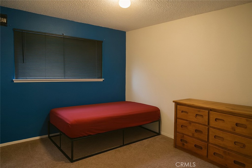 2757 Branco Avenue Merced, CA 95340 - Photo 16 of 24 a bedroom with a bed and a dresser