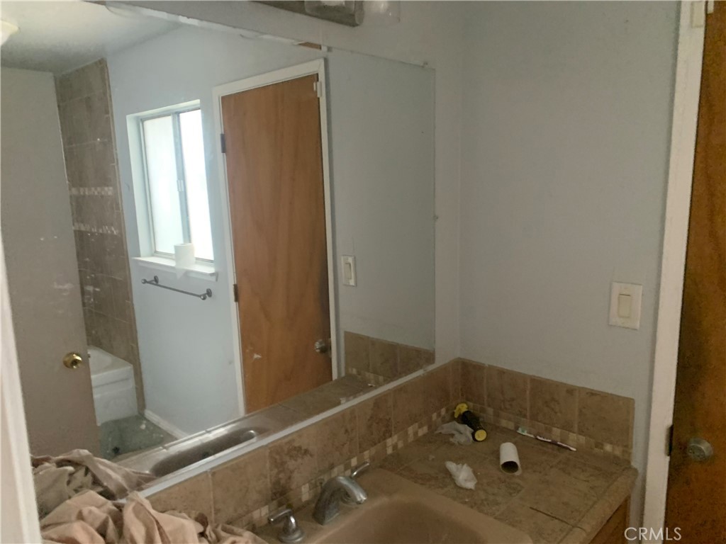 2757 Branco Avenue Merced, CA 95340 - Photo 17 of 24 a bathroom with a sink and a window