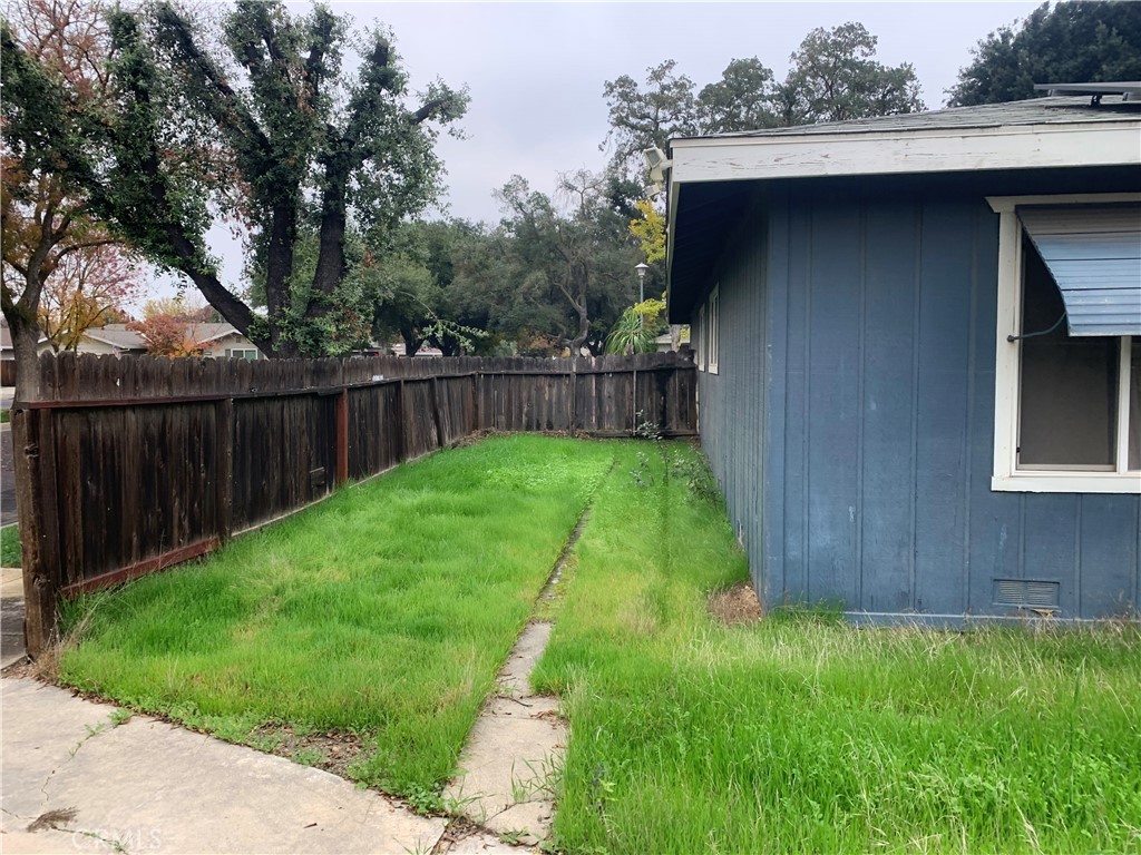 2757 Branco Avenue Merced, CA 95340 - Photo 20 of 24 a view of a backyard with a small cabin and wooden fence