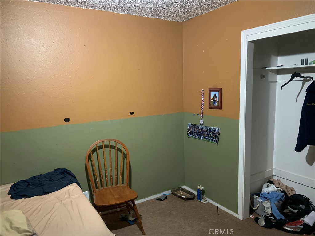 2757 Branco Avenue Merced, CA 95340 - Photo 5 of 24 a bedroom with a bed and a window