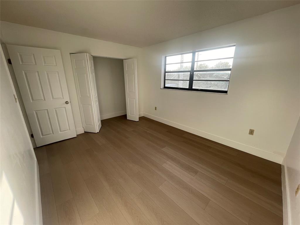 1470 West 41st Street, Unit 201 Hialeah, FL 33012 - Photo 11 of 26 an empty room with windows
