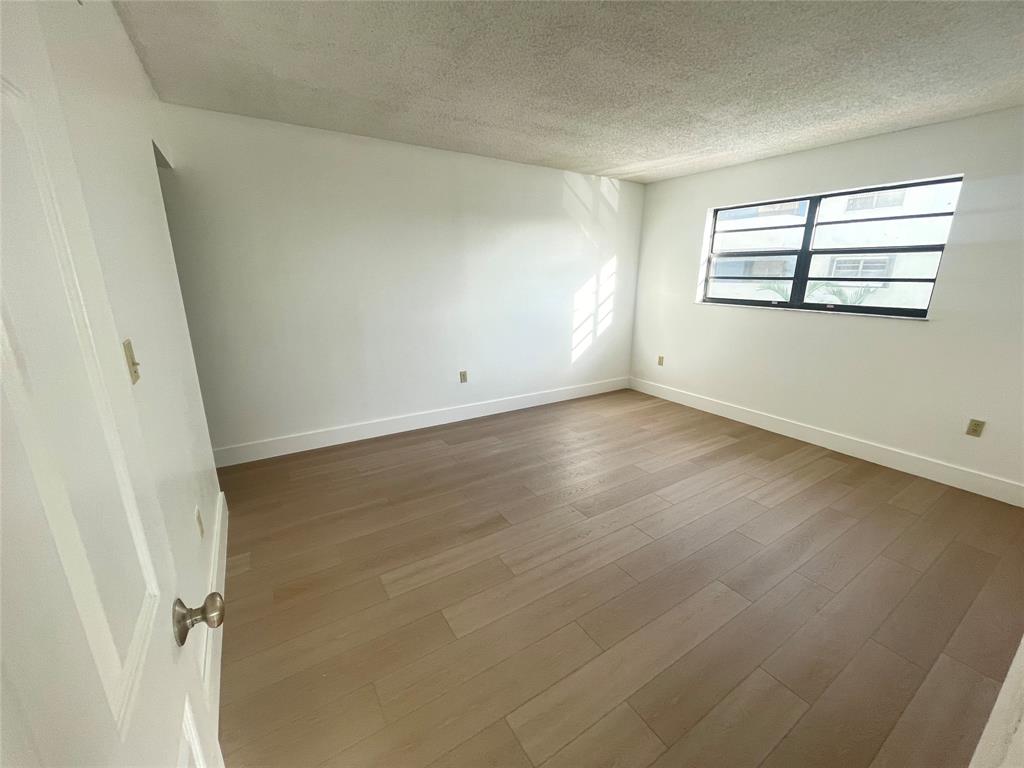 1470 West 41st Street, Unit 201 Hialeah, FL 33012 - Photo 14 of 26 an empty room with windows